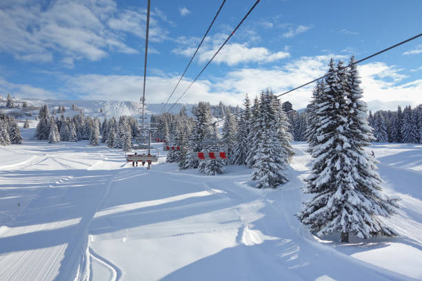 Riding the ski lift on a perfect day. stock photo