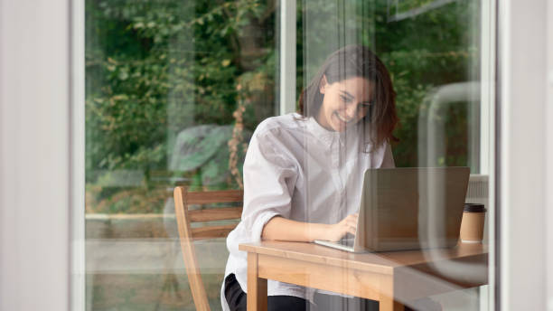 istock Woman working on laptop at cafe 1055560140