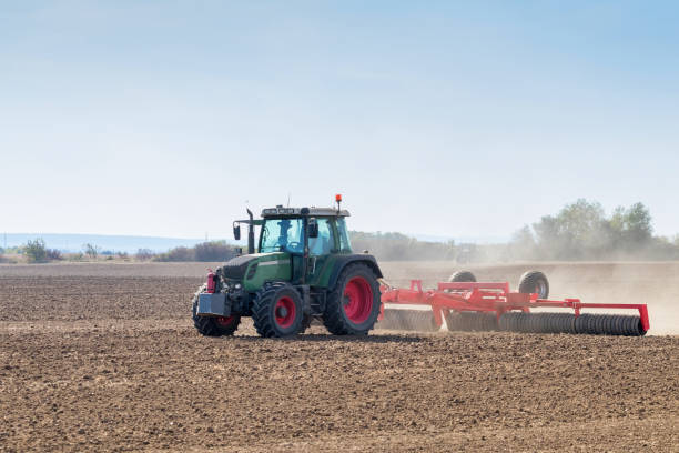 istock Tractor preparing field, Agriculture tractor 1055560252