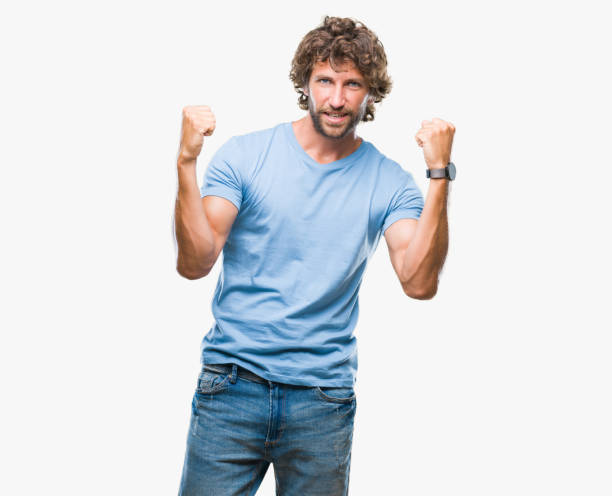 istock Handsome hispanic model man over isolated background celebrating surprised and amazed for success with arms raised and open eyes. Winner concept. 1055560264