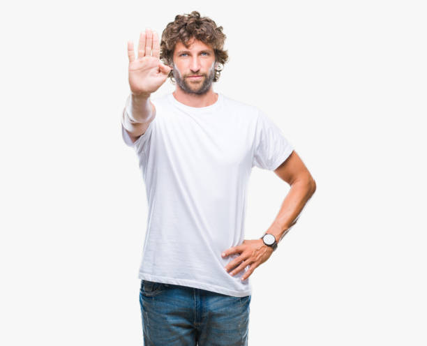 istock Handsome hispanic model man over isolated background doing stop sing with palm of the hand. Warning expression with negative and serious gesture on the face. 1055560338