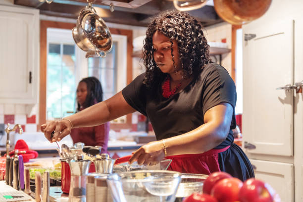 istock African-American preparing thanksgiving dinner 1055560722