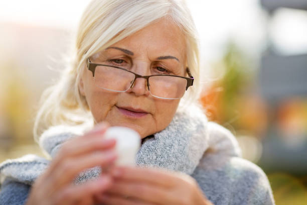 istock Senior woman checking label on medication 1055560752