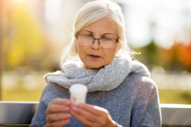 istock Senior woman checking label on medication 1055560890