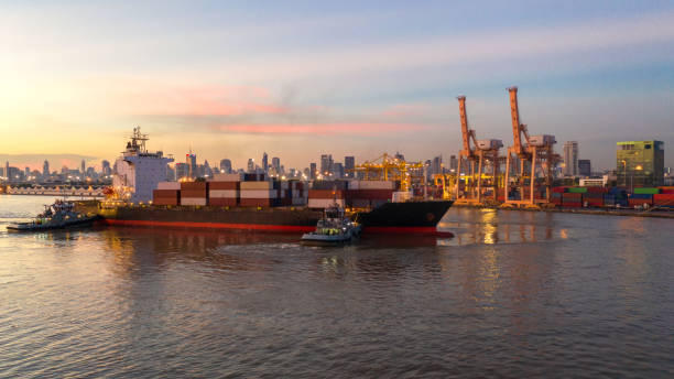 istock Container ship in export and import business and logistics. Shipping cargo to harbor by crane. Water transport International. Aerial view and top view. 1055567954