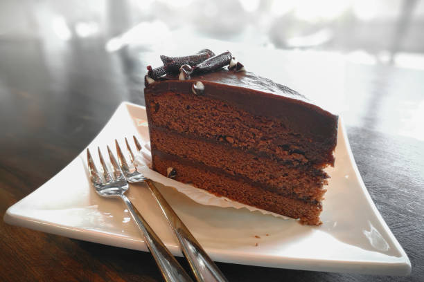 istock Delicious chocolate cake in plate on table 1055576488