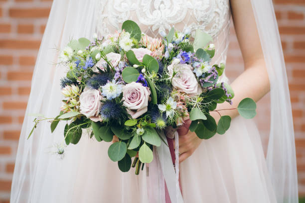 istock Wedding bouquet in the hands of the bride 1055577434