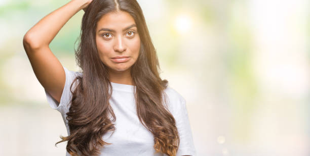 istock Young beautiful arab woman over isolated background confuse and wonder about question. Uncertain with doubt, thinking with hand on head. Pensive concept. 1055579314