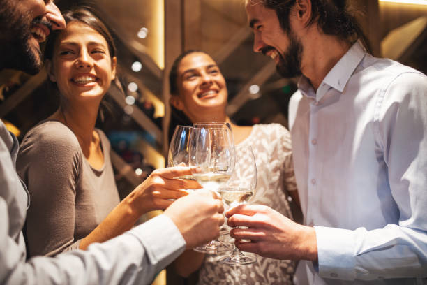 istock Happy couples taste wine in the restaurant 1055579466