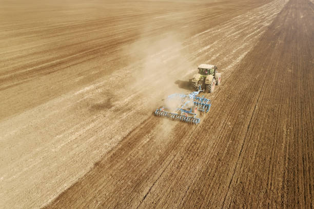 istock Aerial view Tractor preparing field, Agriculture tractor landscape 1055579604