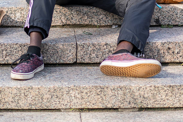 istock Close-up man's legs sitting in park 1055583506