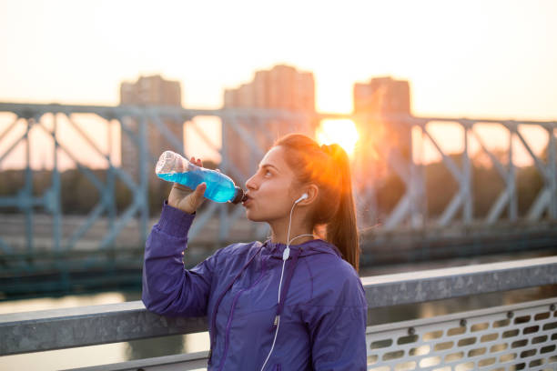 istock Woman drinking vitamin water 1055586888