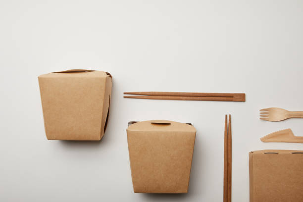 istock elevated view of arranged wok boxes, chopsticks and disposable knife with fork on white surface 1055587732