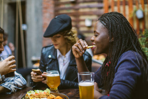 istock Friends Chatting Over a Beer on a Dinner 1055588050