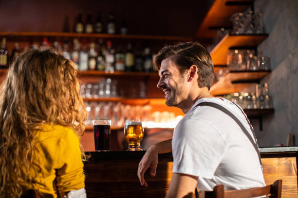 istock Young People Drinking Beer On Date at Bar 1055589924