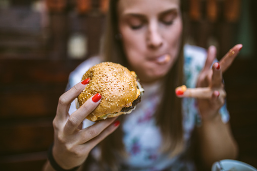 Mujer disfrutando de la deliciosa hamburguesa photo