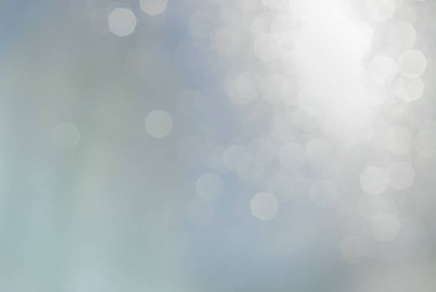 istock Bokeh abstract texture. Beautiful christmas background in light blue colors. Defocused 1055591288