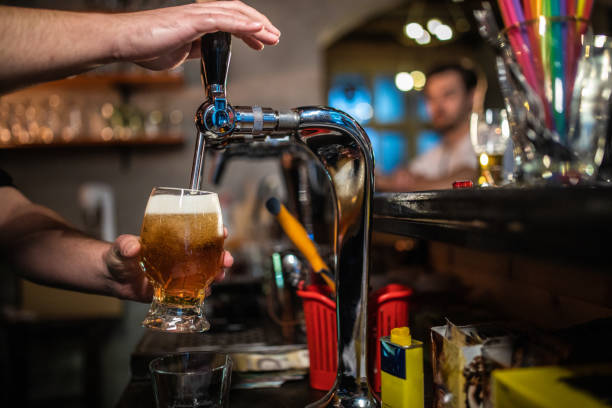 istock Bartender Pours Glass of Beer 1055593476