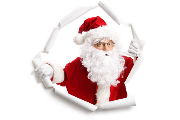 istock Santa Claus emerging from a paper hole 1055597068