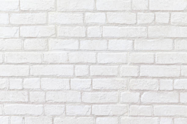 istock close up of weathered white brick wall texture background. 1055597488