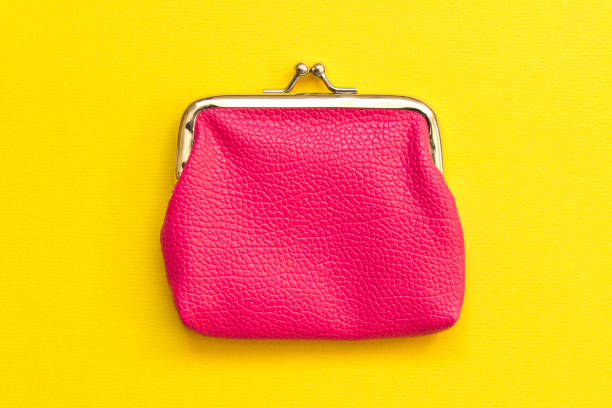 istock Pink wallet on yellow background . Close up. Top view 1055601706