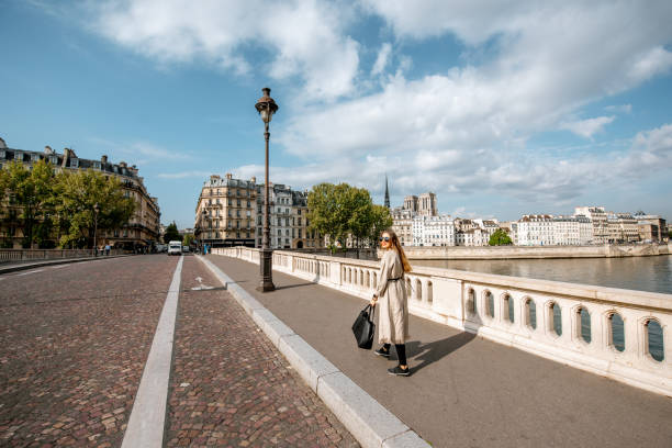istock Street view with woman walking in Paris 1055603144