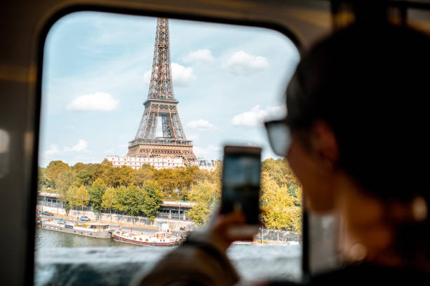 istock Woman photographing eiffel tower in Paris 1055603178