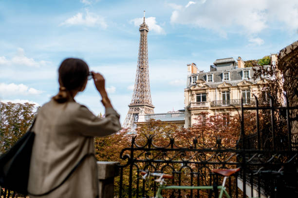 istock Woman looking on the Eiffel tower in Paris 1055603396