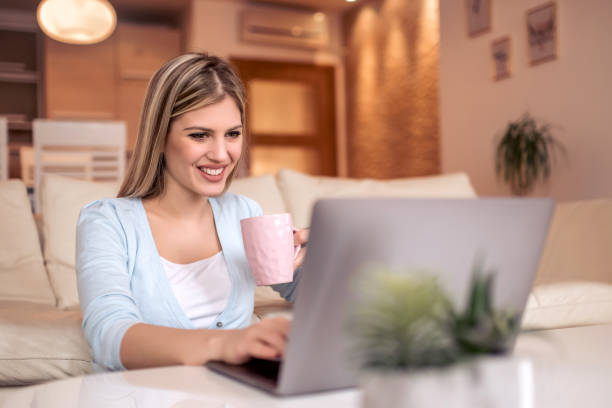 istock Happy beautiful woman working on a laptop 1055604580