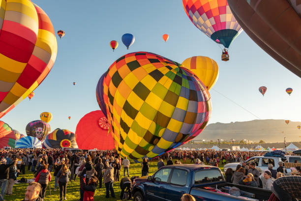 Hot Air Balloon Festival in Albuquerque Hot Air Balloon Festival in Albuquerque. Photo taken during a cold October morning when there are hundreds of balloons ascending shortly after dawn. ballooning festival stock pictures, royalty-free photos & images