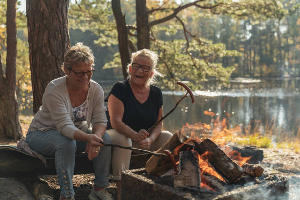 istock Senior ladies barbecuing outdoors 1055608412