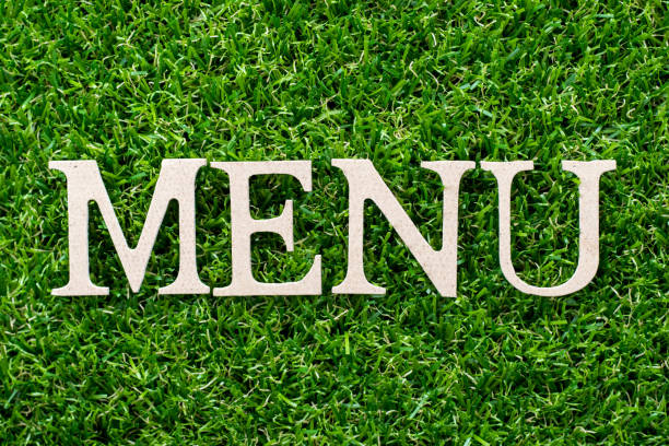 istock Wood letter in word menu on artificial green grass background 1055609182