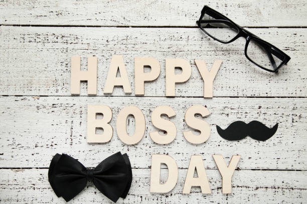 istock Inscription Happy Boss Day with glasses and bow tie 1055612762
