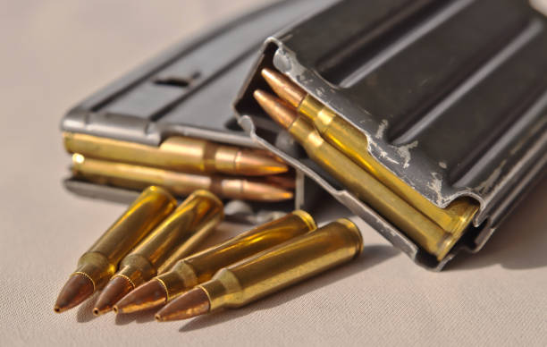 istock Two rifle magazines with four bullets in front of them 1055614514