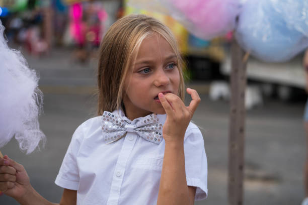 Pretty 7 years old blue eyes girl enjoying at the fair of her town