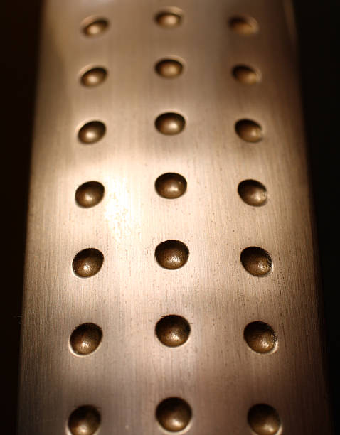 istock spherical metal surface background with holes 105561582