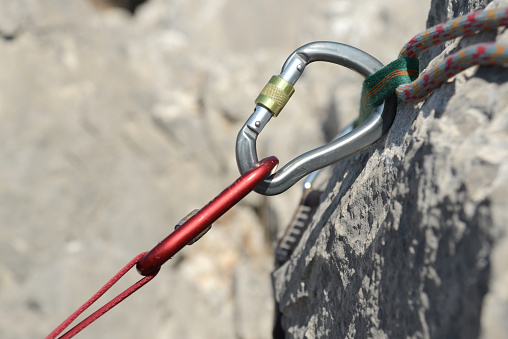A male climber climbs a mountain using a special rope and climbing equipment