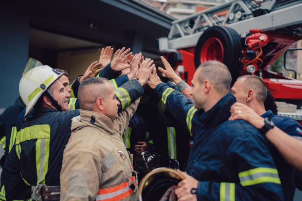 Firefighters doing high five stock photo