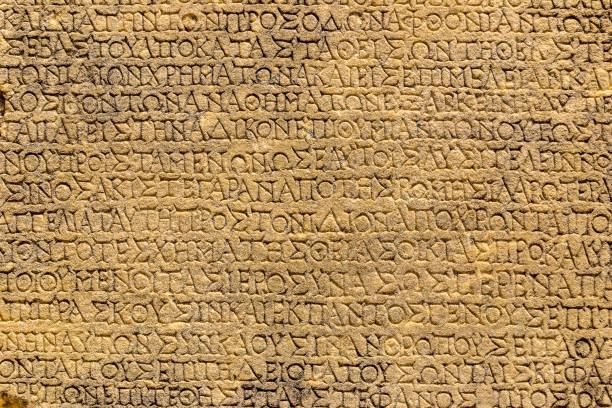 EPHESUS, TURKEY - JULY 26, 2014: Ancient greek script, Celsus Library, Ephesus Turkey EPHESUS, TURKEY - JULY 26, 2014: An appearance from the ancient city of Ephesus and inscribed ancient stones. Celsus Library, Ephesus Turkey. celsus library photos stock pictures, royalty-free photos & images