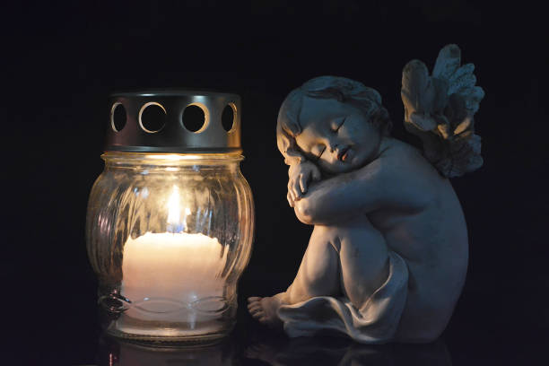 istock Guardian angel and burning candle 1055625968