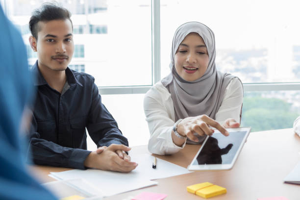 istock Businesswoman uses digital tablet during meeting 1055627770