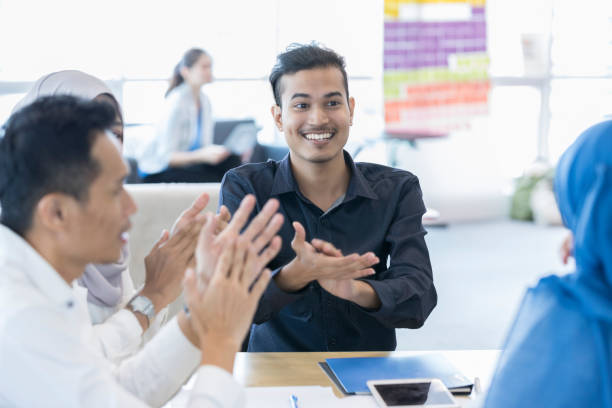 istock Business people applaud colleague's presentation 1055627804