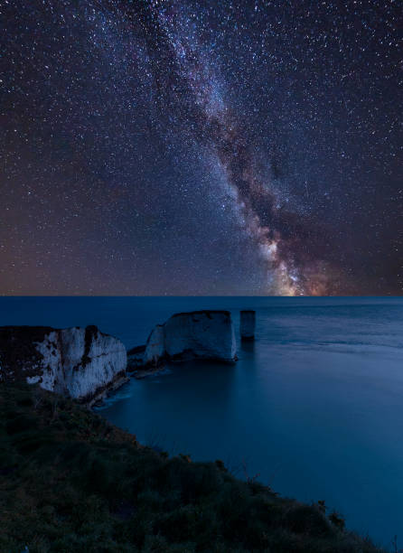 istock Vibrant Milky Way composite image over landscape of Stunning cliff formation 1055628418