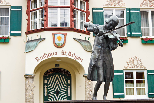 Statue of young Wolfgang Amadeus Mozart in front of townhall on Mozartplatz in St. Gilgen, Austria