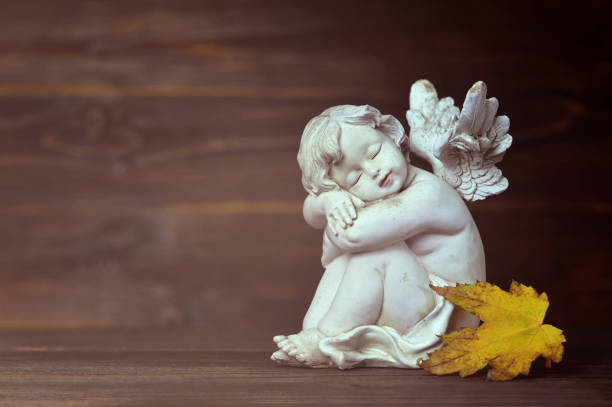 istock Guardian angel and yellow autumn leaf 1055642312