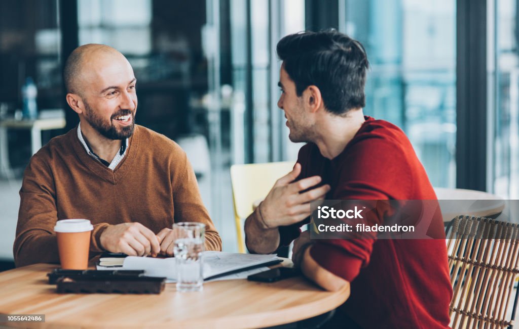 Meeting at cafe Business persons in informal discussion Discussion Stock Photo