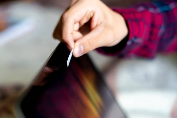 istock close up hand blocks the webcam with a white sticker tape  f 1055643304