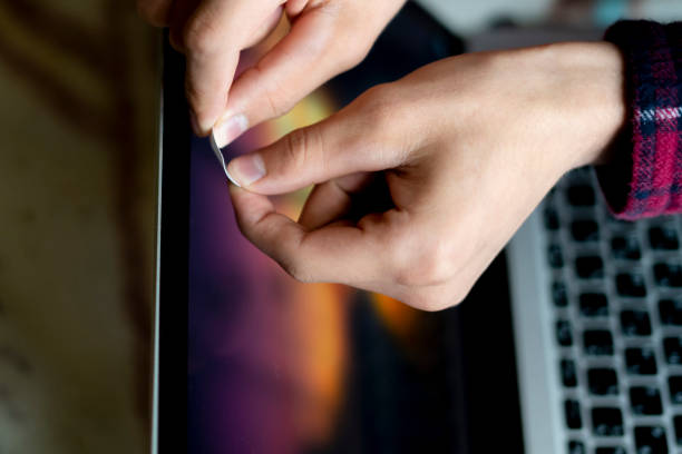 istock close up hand blocks the webcam with a white sticker tape  f 1055643306