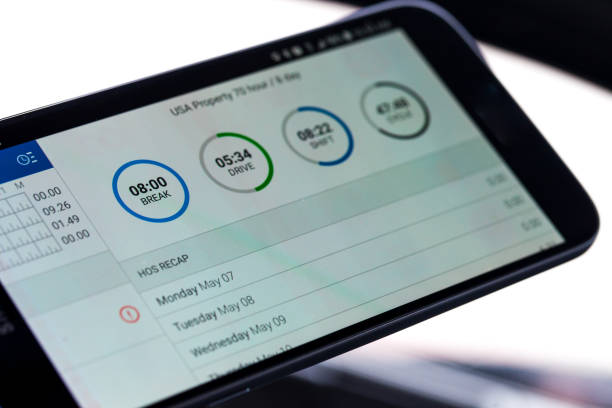 electronic logging device for trucking industry with hours of service displayed on smartphone screen - forest industry imagens e fotografias de stock