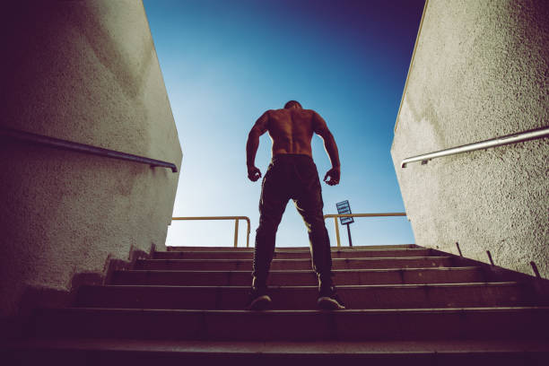 istock Muscular man on a staircase 1055648744